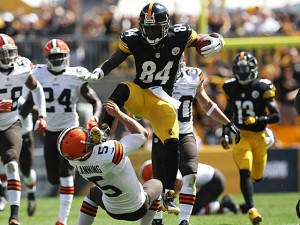 Sep 7, 2014; Pittsburgh, PA, USA; Pittsburgh Steelers wide receiver Antonio Brown (84) runs over Cleveland Browns punter Spencer Lanning (5) during the first half at Heinz Field. Brown was flagged on the play. Mandatory Credit: Jason Bridge-USA TODAY Sports